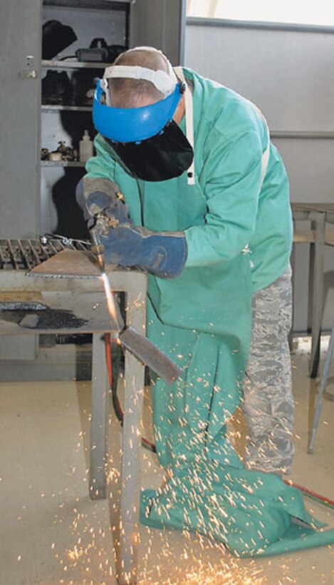 Airman Robert Clark, Class 09021, practices cutting metal, April 24, at TA 244 during Pavement and Equipment Apprentice Course. Airmen in the course spend 69 days learning how to operate everything from front-end loaders, road graders and bulldozers to backhoes, dumps trucks and skid steer loaders. 
