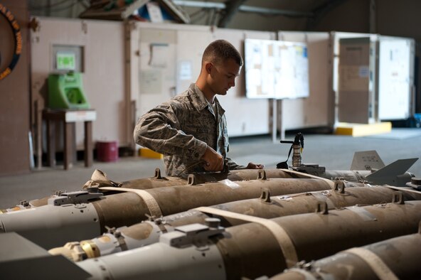 Airman 1st Class Brian Foster, 379th Expeditionary Maintenance Squadron munitions flight conventional maintenance journeyman, attaches a grounding wire to a GBU-38 to test its fin operability, July 20, in Southwest Asia.  The 379 EXMS munitions flight provides aircraft with both offensive and defensive devices to support various air tasking orders throughout the U.S. Central Command area of responsibility. Airman Foster is a native of Ellijay, Ga., and deployed from Dyess Air Force Base, Texas in support of Operations Iraqi and Enduring Freedom. (U.S. Air Force Photo/Staff Sgt. Robert Barney)