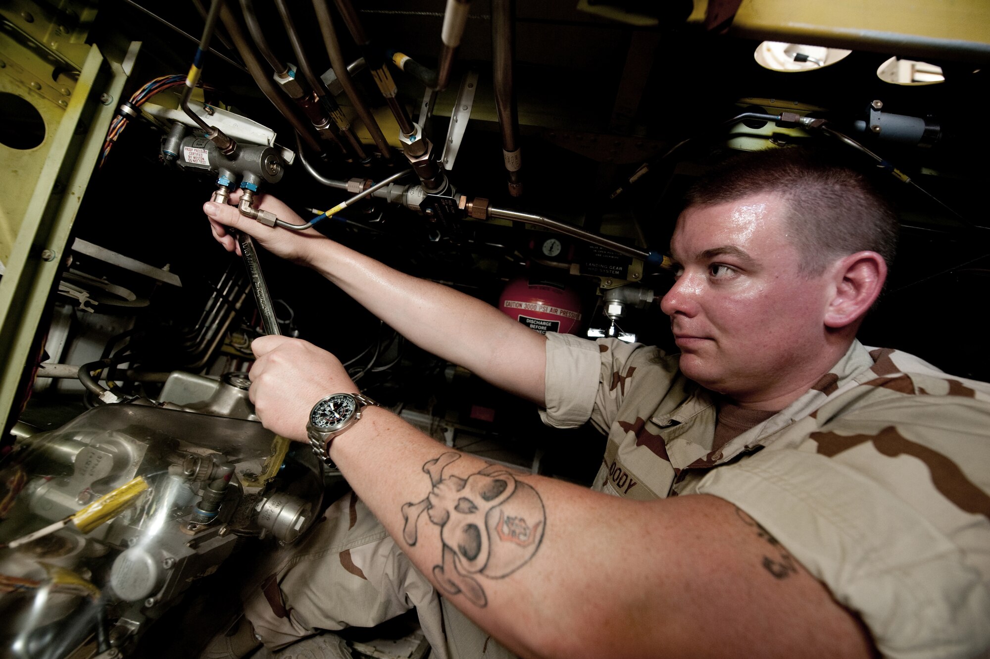 Petty Officer 2nd Class Robert Moody, Navy Patrol Squadron 10 aviation structural mechanic, replaces a hydraulic line on a P-3C Orion, July 27, in Southwest Asia. The P-3C provides an over-watch of U.S. and Coalition Forces, gathering intelligence to assist them on the ground and on the sea. Petty Officer Moody is deployed in support of Operations Iraqi and Enduring Freedom. (U.S. Air Force Photo/Staff Sgt. Robert Barney)