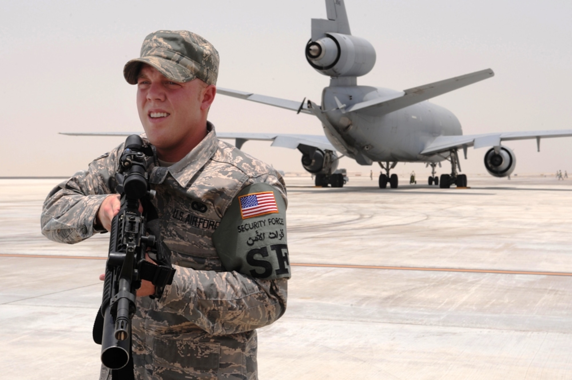 Senior Airman Zachery Deason, from the 380th Expeditionary Security Forces Squadron at an undisclosed location in Southwest Asia, stands guard in a position called over watch during an exercise July 21, 2009. A KC-10 Extender can be seen behind him. Airman Deason is deployed from Sheppard Air Force Base, Texas, and hails from Wichita Falls, Texas. (U.S. Air Force Photo/Tech. Sgt. Charles Larkin Sr.)