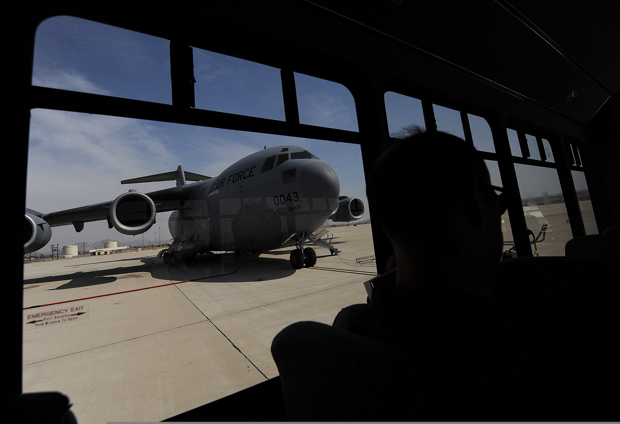 An aircrew from the 729th Airlift Squadron arrives on a crew bus at its C-17A Globemaster III cargo aircraft July 24, 2009, before flying the Cactus mission from the 452nd Air Mobility Wing at March Air Reserve Base, Calif. The Cactus provides aircrew training for C-17 crews while at the same time providing transportation to and from their unit training assembly or drill weekend at March ARB for Airmen from Arizona and Nevada. (U.S. Air Force Photo/Master Sgt. Rick Sforza)