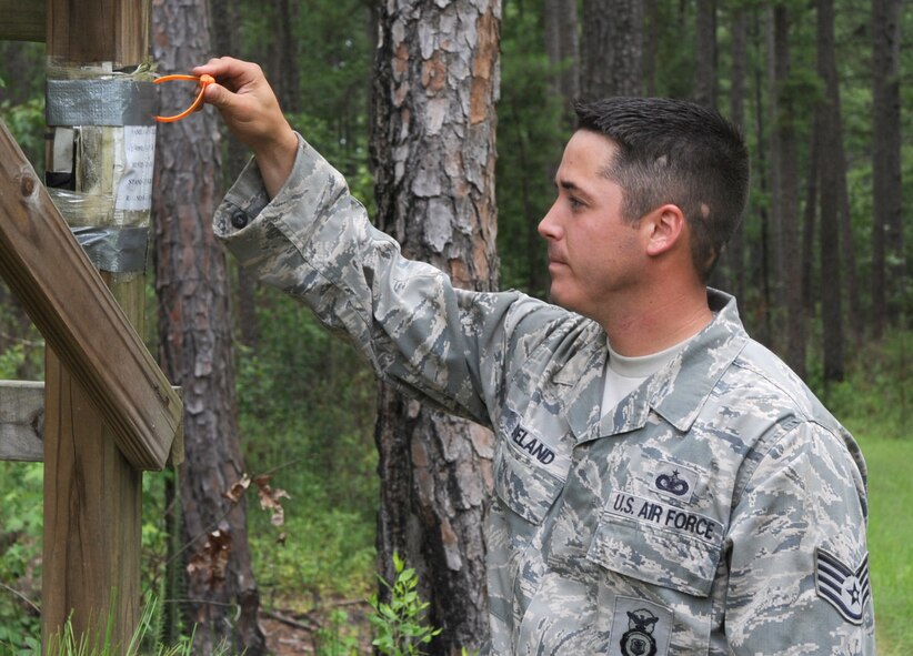 BARKSDALE AIR FORCE BASE, La. -- Staff Sgt. Christopher Breland, 2d Security Force Squadron, checks the inspection tag on a deer stand on the East Side of base during his routine checks as a game warden. (United States Air Force photo by Senior Airman Alexandra Longfellow) 
