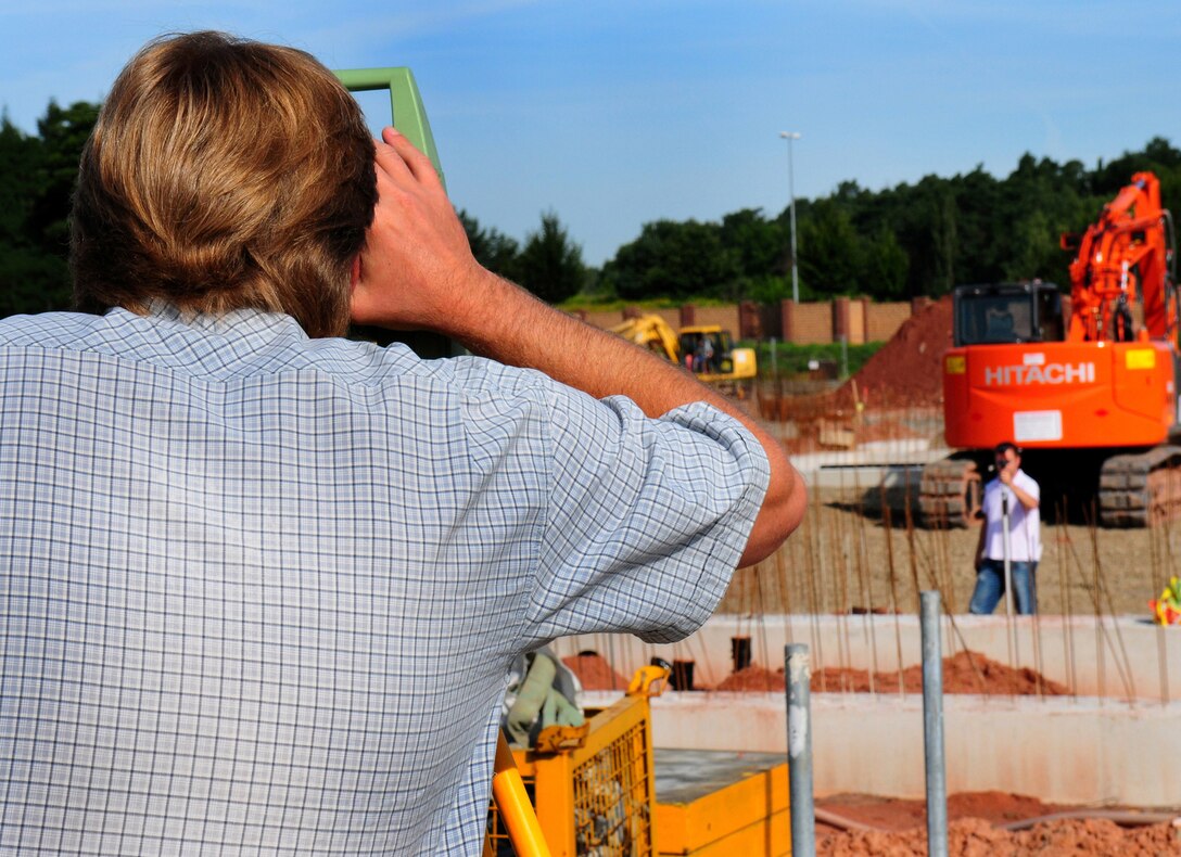 Karsten Reim and Kaiuwe Natale from VT Data Company take survey measurements at the future site of the new Joint Mobility Processing Center on Ramstein Air Base, Germany, 29 July 2009.  (U.S. Air Force photo by Staff Sgt. Jocelyn Rich)