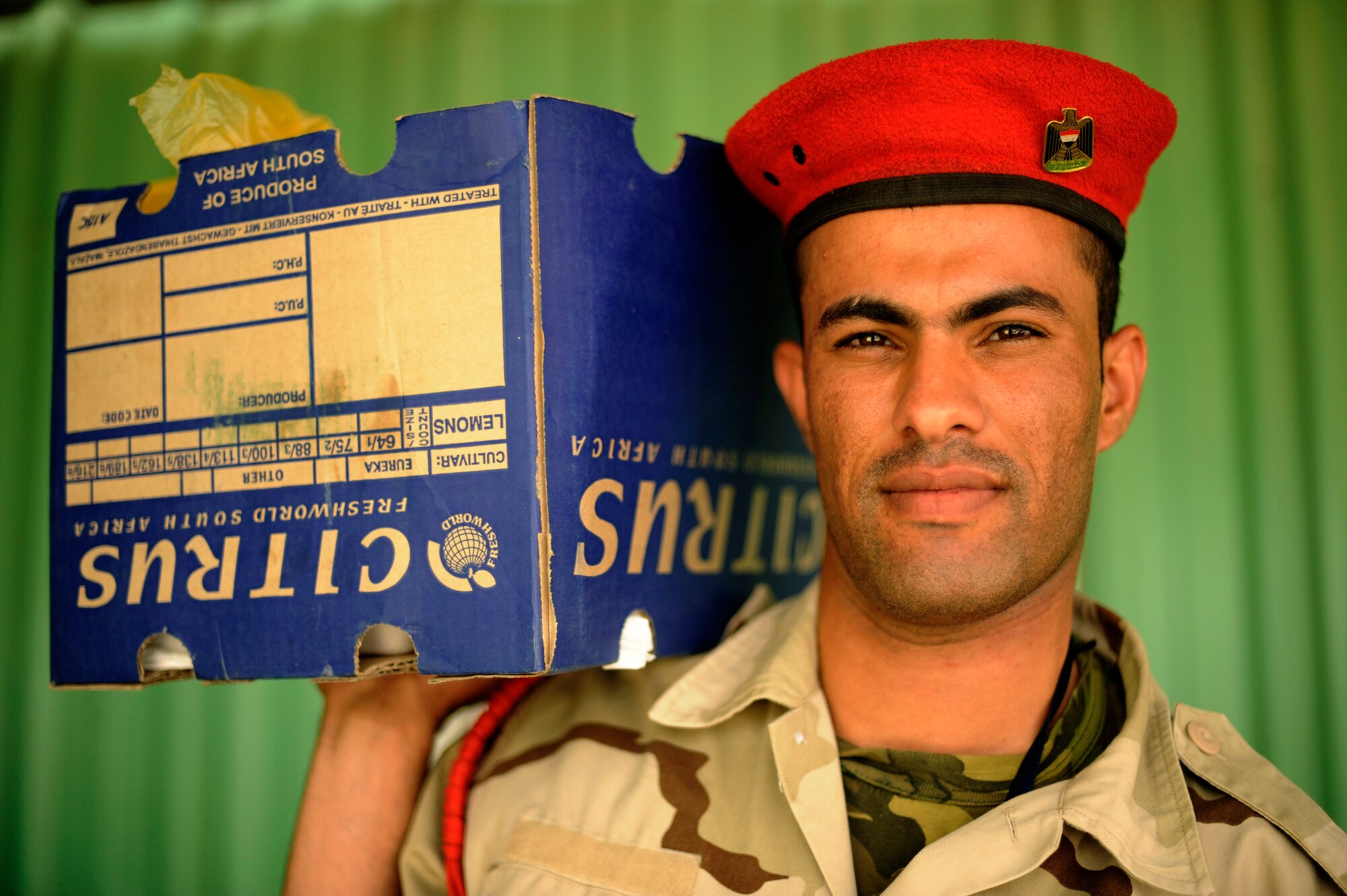 An Iraqi Soldier carries a box of food from an Iraqi dining facility for his fellow Soldiers pulling guard duty at Camp Taji, Iraq, July 12, 2009.   This dining facility is run exclusively by the Iraqi Army with some assistance from an American Airman assigned to the Logistics Military Advisor Team.  (U.S. Air Force photo by Staff Sgt. Michael B. Keller) (Released) 
