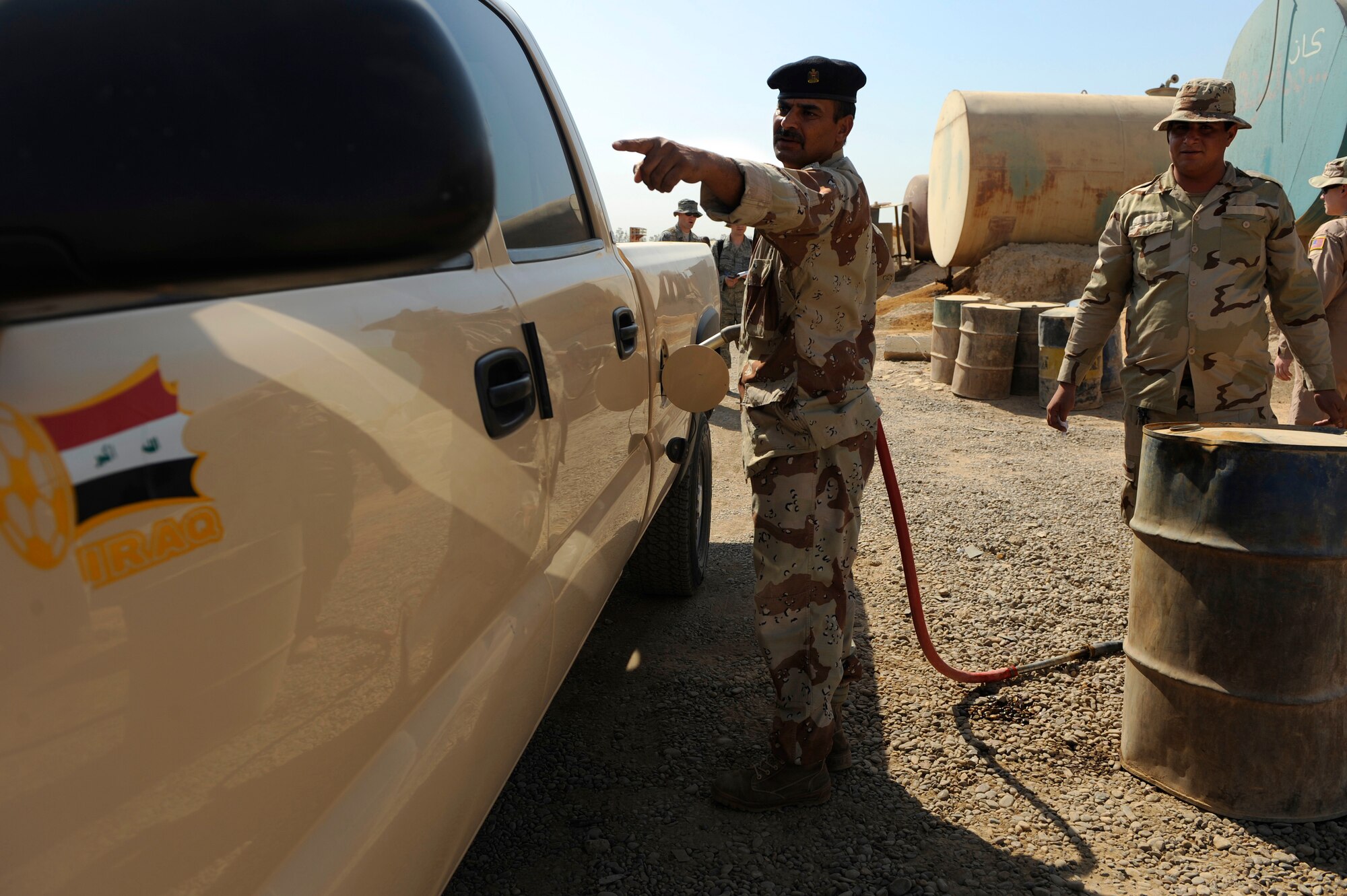 Iraqi soldiers refuel their vehicles at Camp Taji, Iraq, July 11, 2009.  The Iraqi fuels depot is run exclusively by the Iraqi Army with some assistance from an American Airman assigned to the Logistics Military Advisor Team.  (U.S. Air Force photo by Staff Sgt. Michael B. Keller) (Released)
