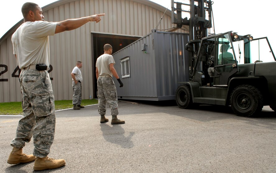 Airmen relocate a conex in tent city in preparation for Ulchi Freedom Guardian, a joint bilateral exercise expected to start in August. More than 550 military members will participate in the exercise. UFG is a regularly scheduled summer exercise involving forces from both the Republic of Korea and the U.S.   (U.S. Air Force photo/Senior Airman Stephenie Wade)