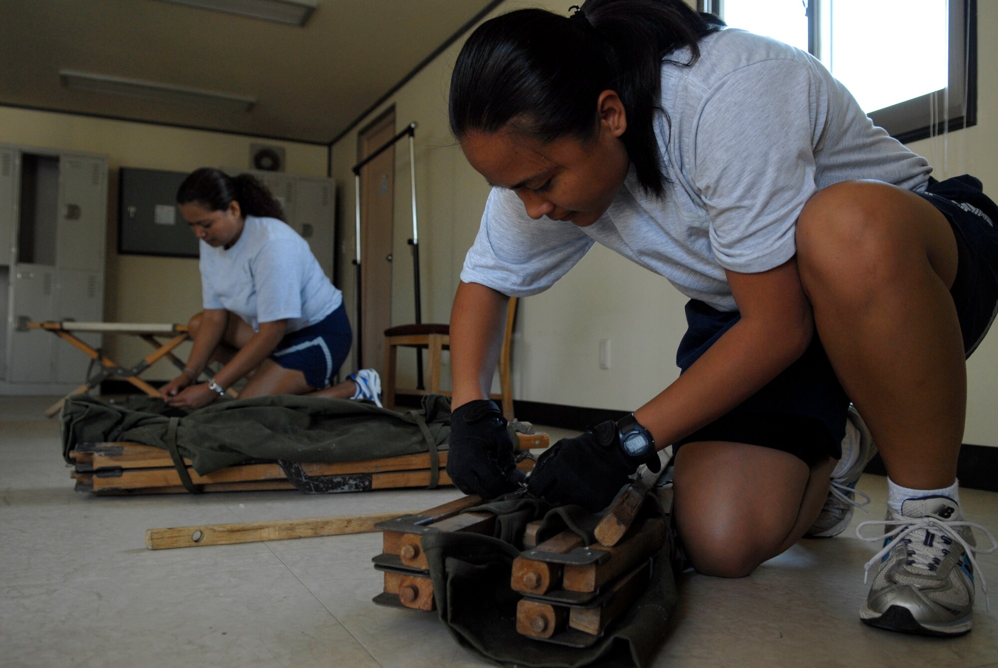 Staff Sgt. Venessa Salas, (Right), and Staff Sgt. Cindy Fejaran unpack and assemble cots in preparation for Ulchi Freedom Guardian, a joint bilateral exercise expected to start in August. More than 550 military members will participate in the exercise. UFG is a regularly scheduled summer exercise involving forces from both the Republic of Korea and the U.S. Sergeants Sala and Fejaran are deployed here from the 254th Force Support Squadron, Andersen Air Base, Guam. (U.S. Air Force photo/Senior Airman Stephenie Wade)

