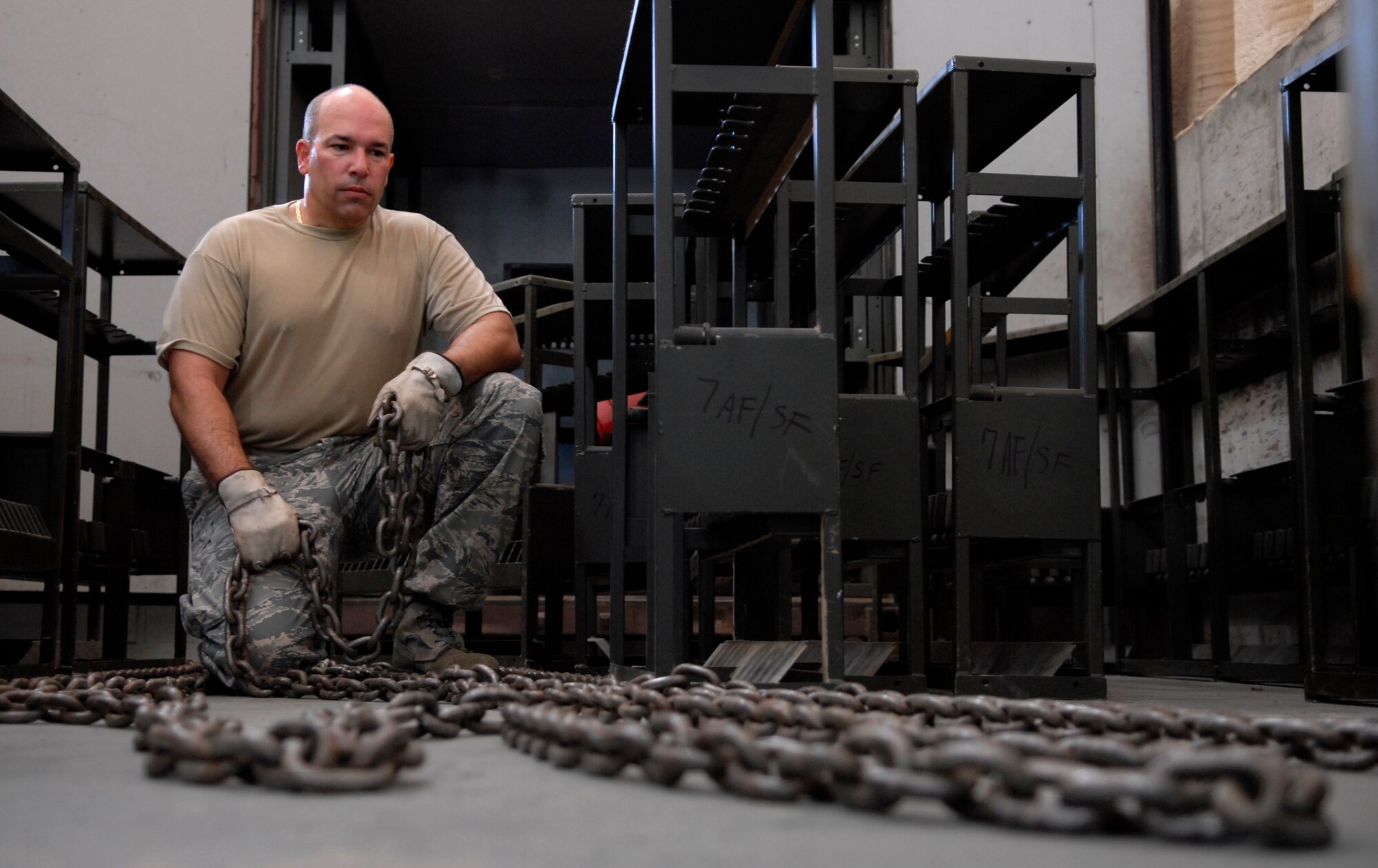 Master Sgt. Michael Cohen lays out chain to connect rifle racks together at Rush Park (tent city) on Osan Air Base, Republic of Korea July 28. Sergeant Cohen is setting up the racks in preparation for Ulchi Freedom Guardian, a joint bilateral exercise expected to start in August. More than 550 military members will participate in the exercise. UFG is a regularly scheduled summer exercise involving forces from both the Republic of Korea and the U.S.  Sergeant Cohen is the armory non-commissioned officer in charge, and is deployed here from Homestead Air Force Base, Fla.  (U.S. Air Force photo/Senior Airman Stephenie Wade)

