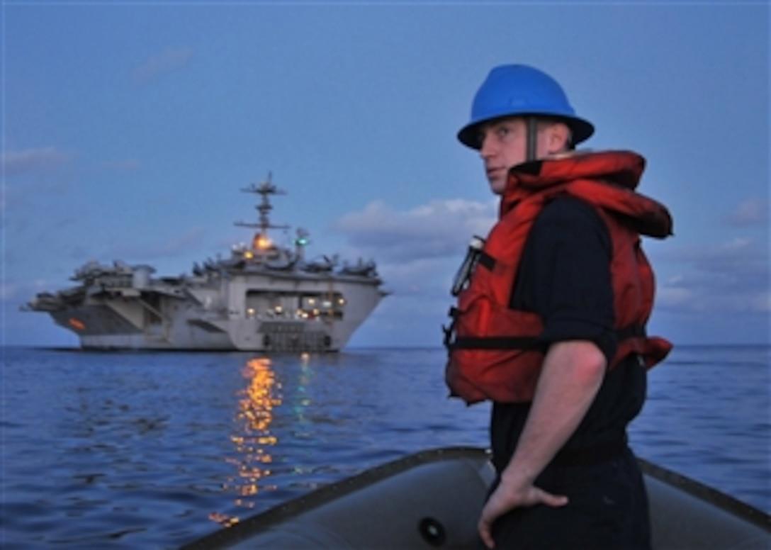 U.S. Navy Petty Officer 3rd Class Thomas McKiernan, assigned to the deck department aboard the aircraft carrier USS George Washington (CVN 73), prepares to approach the stern dock in a rigid hull inflatable boat during coxswain training in the Pacific Ocean on July 24, 2009.  The George Washington is participating in Talisman Sabre 09, a biennial combined exercise designed to train Australian and U.S. forces in planning and conducting combined operations to improve interoperability.  