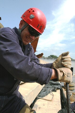 Lt. Col. Charles Long, executive officer, Chemical Biological Incident Response Force, II Marine Expeditionary Force, works to move a piece of concrete using cribbing and shoring techniques at the final practical application for students, during the CBIRF Basic Operations Course, at Navy Annex Stump Neck, Md., July 30, 2009.  Marines and sailors who attended the CBOC learned various techniques for search and extraction during potential chemical, biological, radiological, nuclear and high-yield explosive incidents.