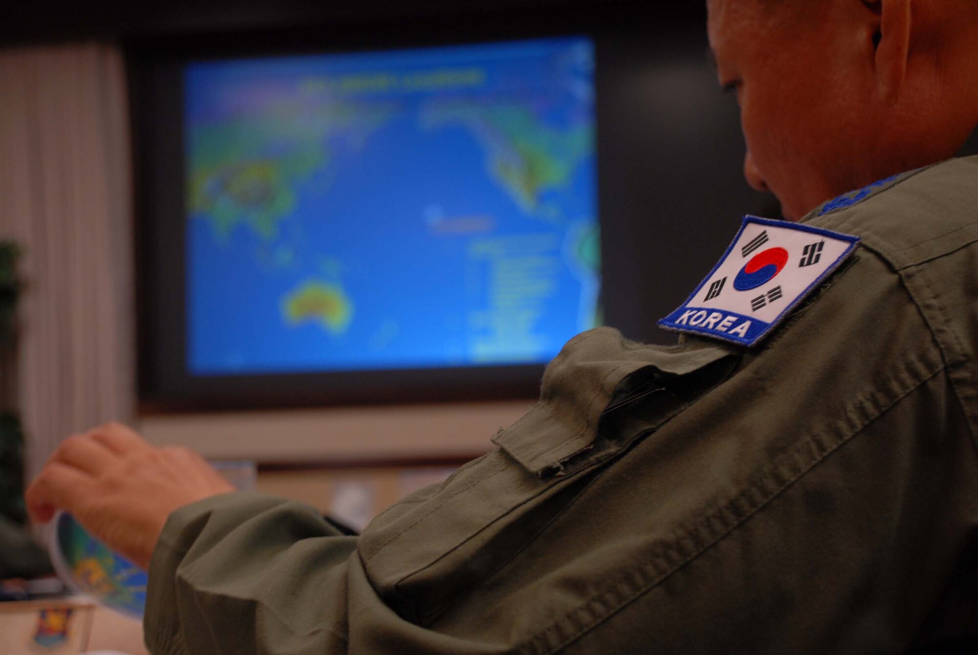 HICKAM AIR FORCE BASE, Hawaii – Col. Soo Cheol Park, Chief of Protocol Branch, Republic of Korea Air Force Headquarters, reviews a mission brief on the 515th Air Mobility Operations Wing during his visit here July 28. Thirty-three ROKAF airmen visited Hickam AFB to tour the wing, see its mission and capabilities, and continue building the good relations the Republic of Korea Air Force has shared with the U.S. Air Force for decades. They stopped in Hawaii en route back to Korea after winning the Best International Team award at the Air Mobility Rodeo 2009 at McChord Air Force Base, Wash., July 19-24. The 515th AMOW controls, loads, unloads, and repairs Pacific en route mobility aircraft, whether military, commercial or foreign, to keep the mission moving with precise, reliable velocity. (U.S. Air Force photo/ Staff Sgt. Carolyn Viss)