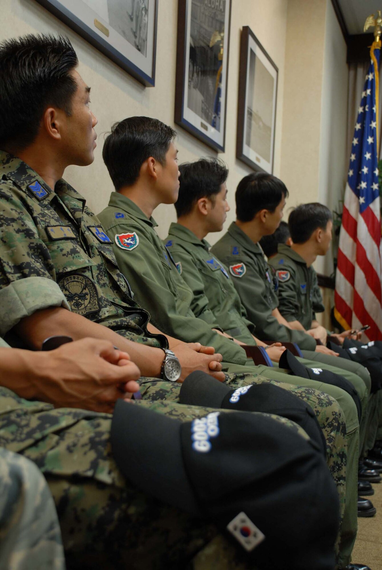 HICKAM AIR FORCE BASE, Hawaii – Republic of Korea Air Force airmen listen to a 515th Air Mobility Operations Wing briefing on the 515th Air Mobility Operations Wing here. Thirty-three members of the ROKAF visited Hickam Air Force Base July 28 to tour the wing, see how its aerial porters conduct day-to-day operations, and continue building good relations the Republic of Korea Air Force has shared with the U.S. Air Force for decades. They stopped in Hawaii en route back to Korea after winning the Best International Team award at the Air Mobility Rodeo 2009 at McChord Air Force Base, Wash., July 19-24. The 515th AMOW controls, loads, unloads, and repairs Pacific en route mobility aircraft, whether military, commercial or foreign, to keep the mission moving with precise, reliable velocity. (U.S. Air Force photo/ Staff Sgt. Carolyn Viss)