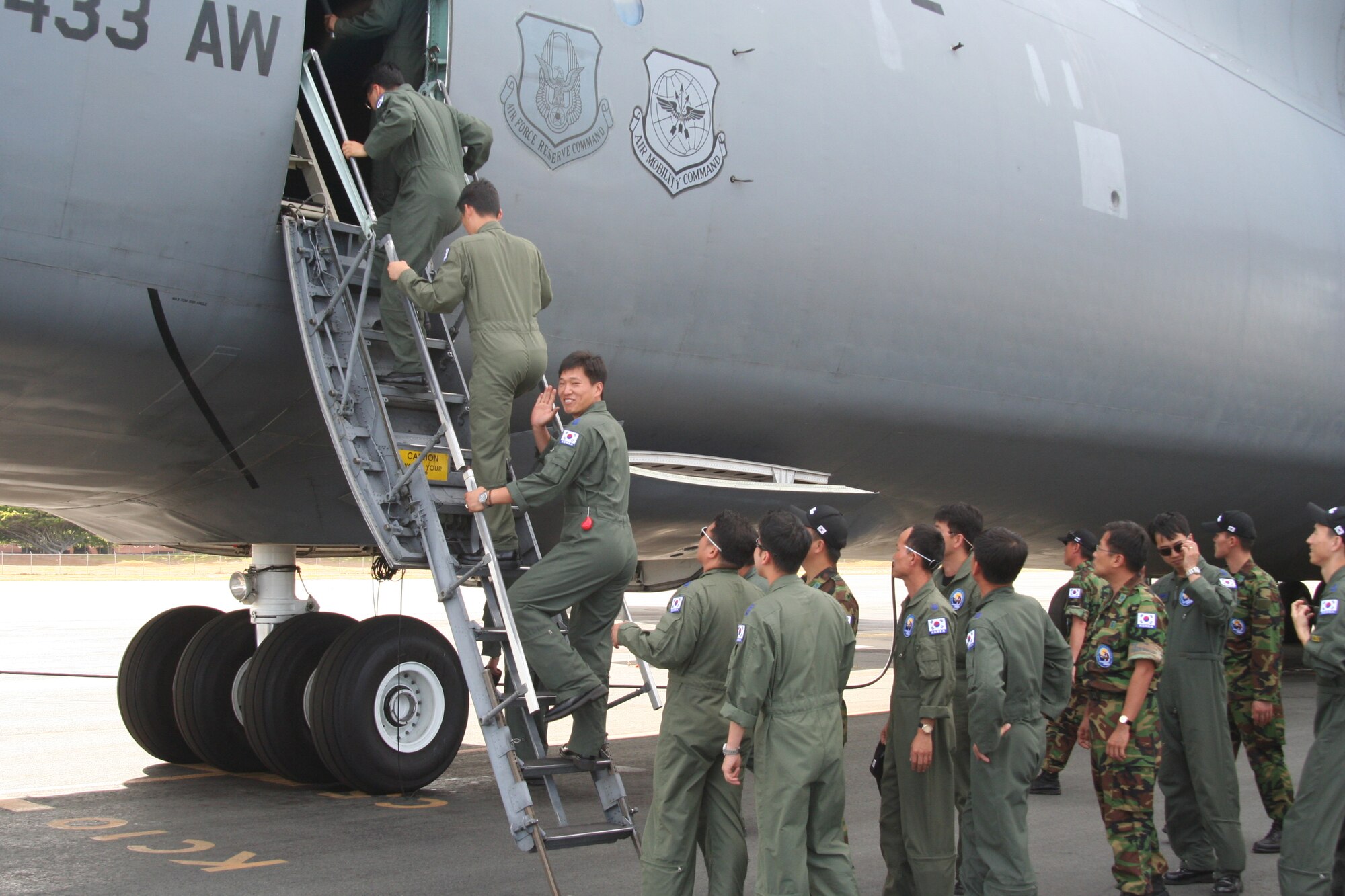 HICKAM AIR FORCE BASE, Hawaii -- Thirty-three Republic of Korea Air Force airmen board a C-5 on the flightline here July 28. They toured the 515th Air Mobility Operations Wing to see its mission and capabilities and continue building the good relations the ROKAF has shared with the U.S. Air Force for decades. They stopped in Hawaii en route back to Korea after winning the Best International Team award at the Air Mobility Rodeo 2009 at McChord Air Force Base, Wash., July 19-24. The 515th AMOW controls, loads, unloads, and repairs Pacific en route mobility aircraft, whether military, commercial or foreign, to keep the mission moving with precise, reliable velocity. (U.S. Air Force photo/ Senior Airman Robert Nelson)
