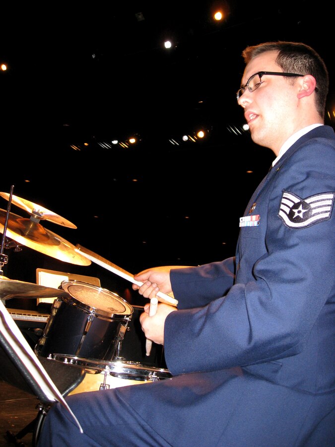 SSgt Adam Benham keeps time with the rhythm section during a holiday performance at Westfield State College, MA.  SSgt Benham lives and works in NYC.