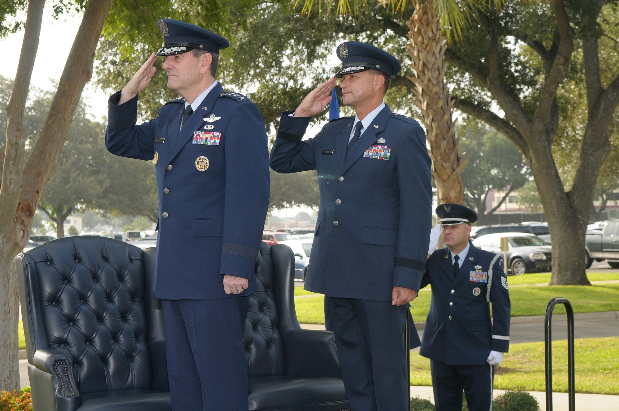 General Stephen R. Lorenz, commander of Air Education and Training Command, and Brig. Gen. Leonard A. “Len” Patrick, 502nd Air Base Wing commander, salute the flag during a ceremony to activate the wing. The 502nd ABW functions as installation management for Joint Base San Antonio, which includes Randolph and Lackland Air Force Bases and Fort Sam Houston. (Air Force Photo by Joel Martinez)