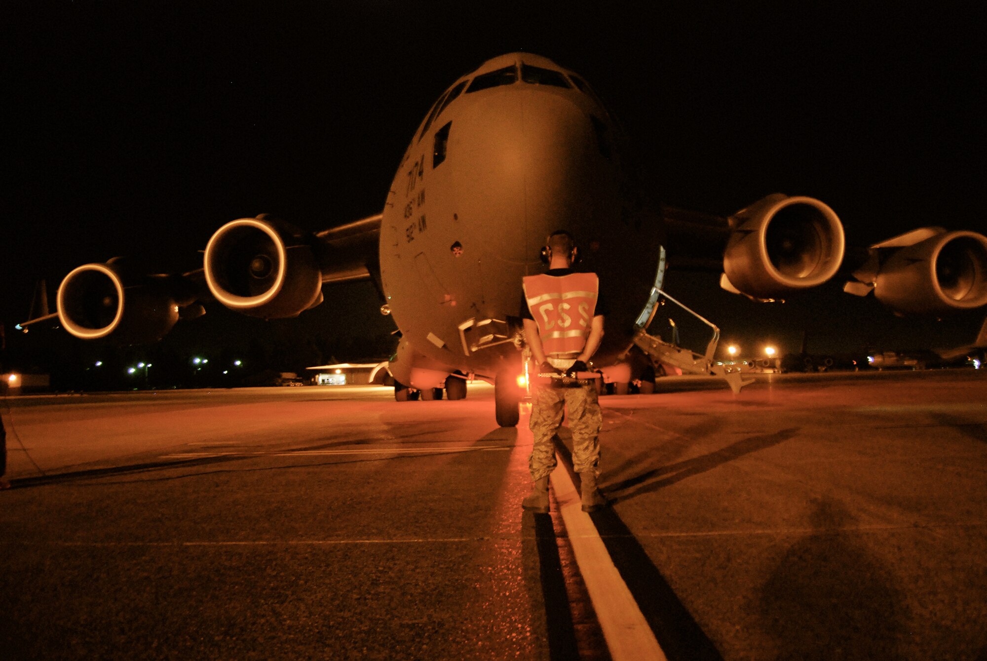 Staff Sgt. Joel Griffith, 712th Aircraft Maintenance Squadron, gets in position to marshal Team Dover's C-17 Globemaster III for takeoff during a nighttime graded evaluation July 21. Sergeant Griffith has been working with other Airmen from the 736th and 712th Maintenance Squadrons to ensure their C-17 runs smoothly throughout the 2009 Air Mobility RODEO, July 19-25, at McChord Air Force Base, Wash. (U.S. Air Force photo/Staff Sgt. Steve Lewis)