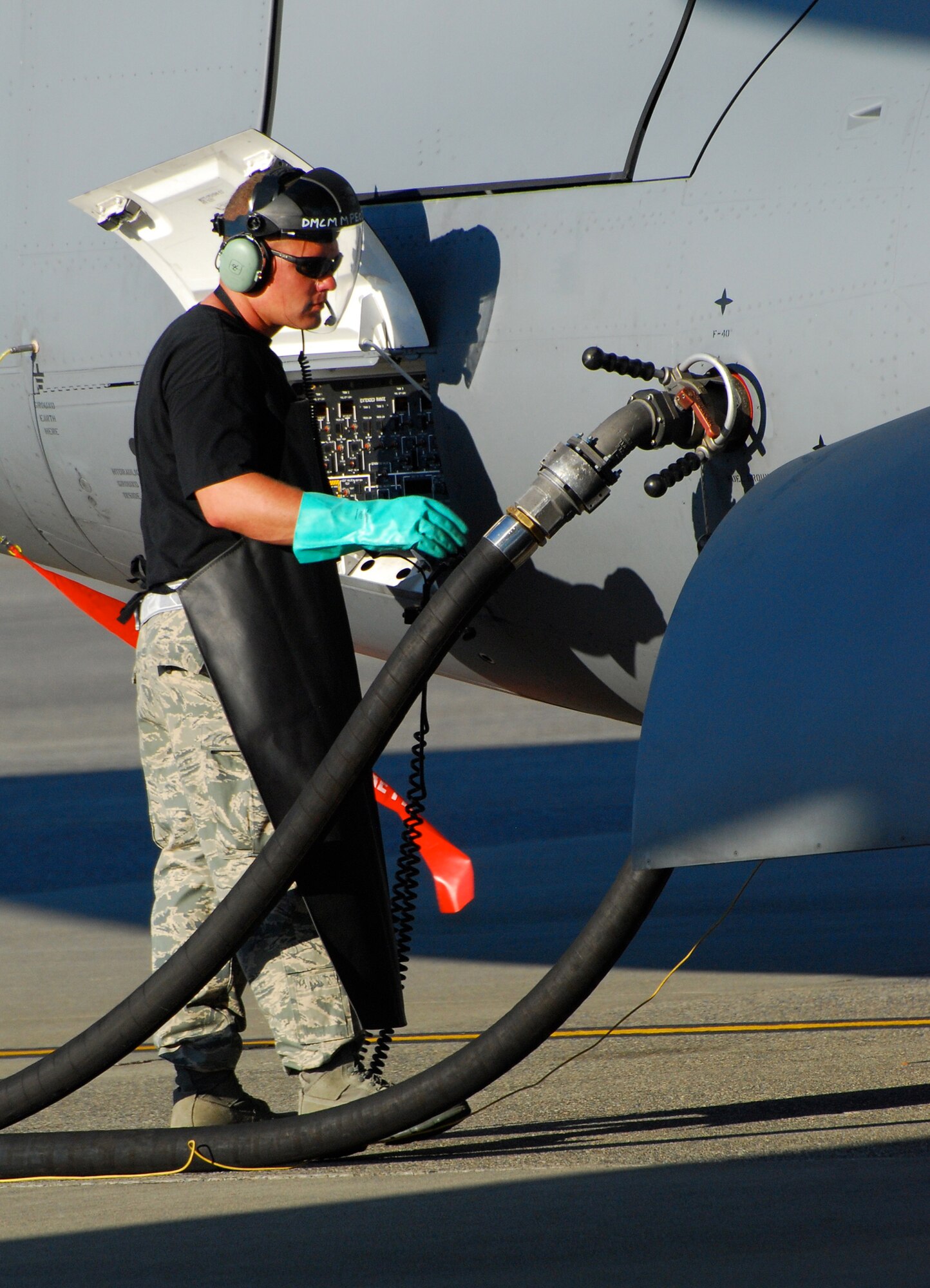 Tech Sgt. Joseph Therrien, 712th Aircraft Maintenance Squadron, pumps fuel into Team Dover's C-17 Globemaster III in preparation for a nighttime graded evaluation, July 21. Sergeant Therrien joins Airmen from the 512th and 436th Airlift Wings in the 2009 Air Mobility RODEO where they are competing in different aspects of airlift operations including maintenance, aerial port, security forces and aircrew events. (U.S. Air Force photo/Staff Sgt. Steve Lewis)
