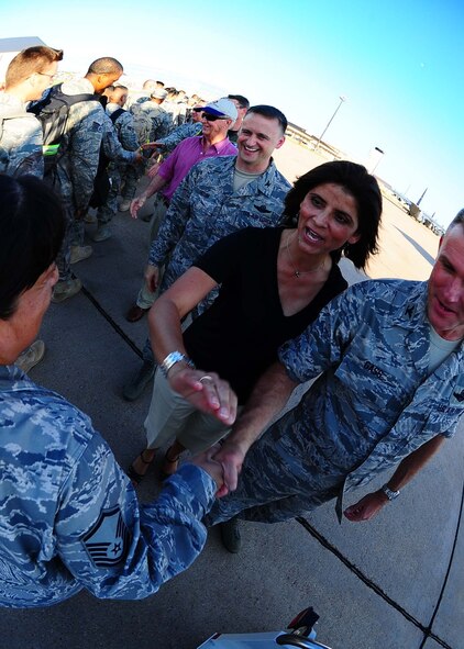 DYESS AIR FORCE BASE, Texas—Col. Robert Gass, 7th Bomb Wing commander, and his wife Patty Gass greet more than 100 Airmen here July 30 who returned from Southwest Asia after a six-month deployment in support of Operations Iraqi and Enduring Freedom. More than 400 Airmen from the 9th Bomb Squadron, 7th Operations Support Squadron, 7th Maintenance Group and 7th Medical Group were deployed. (U.S. Air Force Photo by Airman 1st Class Stephen Reyes)