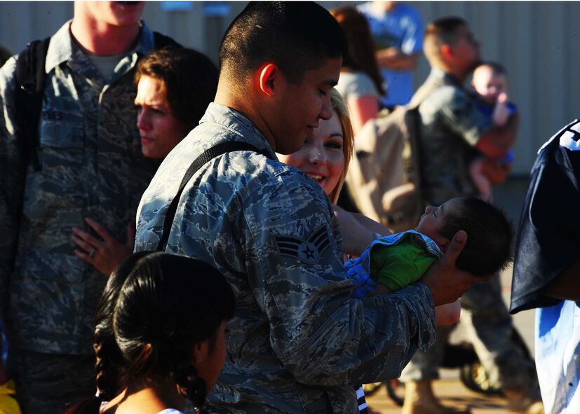 DYESS AIR FORCE BASE, Texas—Airmen and their families embrace here July 30 after a six-month deployment. More than 400 Airmen from the 9th Bomb Squadron, 7th Operations Support Squadron, 7th Maintenance Group and 7th Medical Group were deployed. (U.S. Air Force Photo by Airman 1st Class Stephen Reyes)