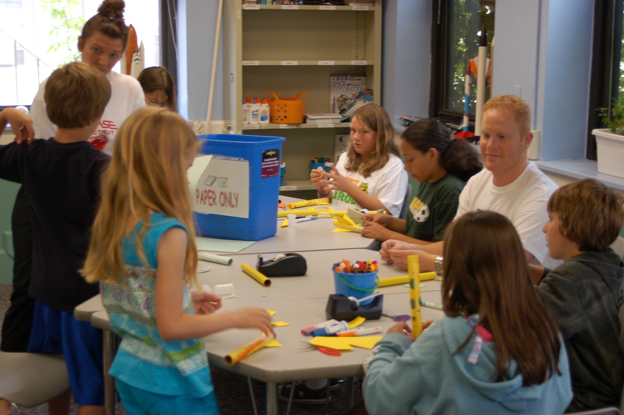 Ryan Martin (right), educator, STARBASE Connecticut, instructs students on how to build a paper rocket for an experiment using Alka-Seltzer and water July 9, 2009 at the STARBASE facility, Brainard Airport, Hartford. STARBASE uses hands-on experiments to teach children about the STEM career fields; Science, Technology, Engineering and Mathematics. (U.S. Air Force photo by Tech. Sgt. Joshua Mead)
