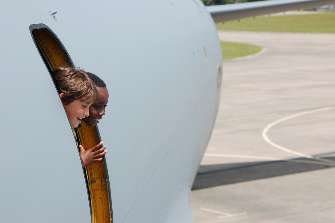 Kwame Hammond Jr. , 10, peeks out the side hatch of a KC-135 along with his friend, Elijah, 9, at Space and Aviation Day at Bradley ANG Base, East Granby, Conn. July 18, 2009. (U.S. Air Force photos by Tech. Sgt. Joshua Mead)