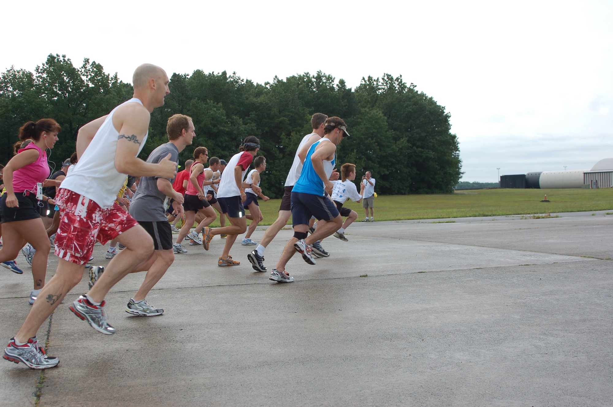 Runners launch off the tarmac at Bradley ANG Base, East Granby, Conn. to start the 5K Space and Aviation Day run in competition and to raise money for the Hole in the Wall Gang Camp July 18, 2009. The race was the beginning event for the Bradley Family Day, Inc. sponsored event that brought in approximately 6,000 dollars.  (U.S. Air Force photo by Tech. Sgt. Joshua Mead)