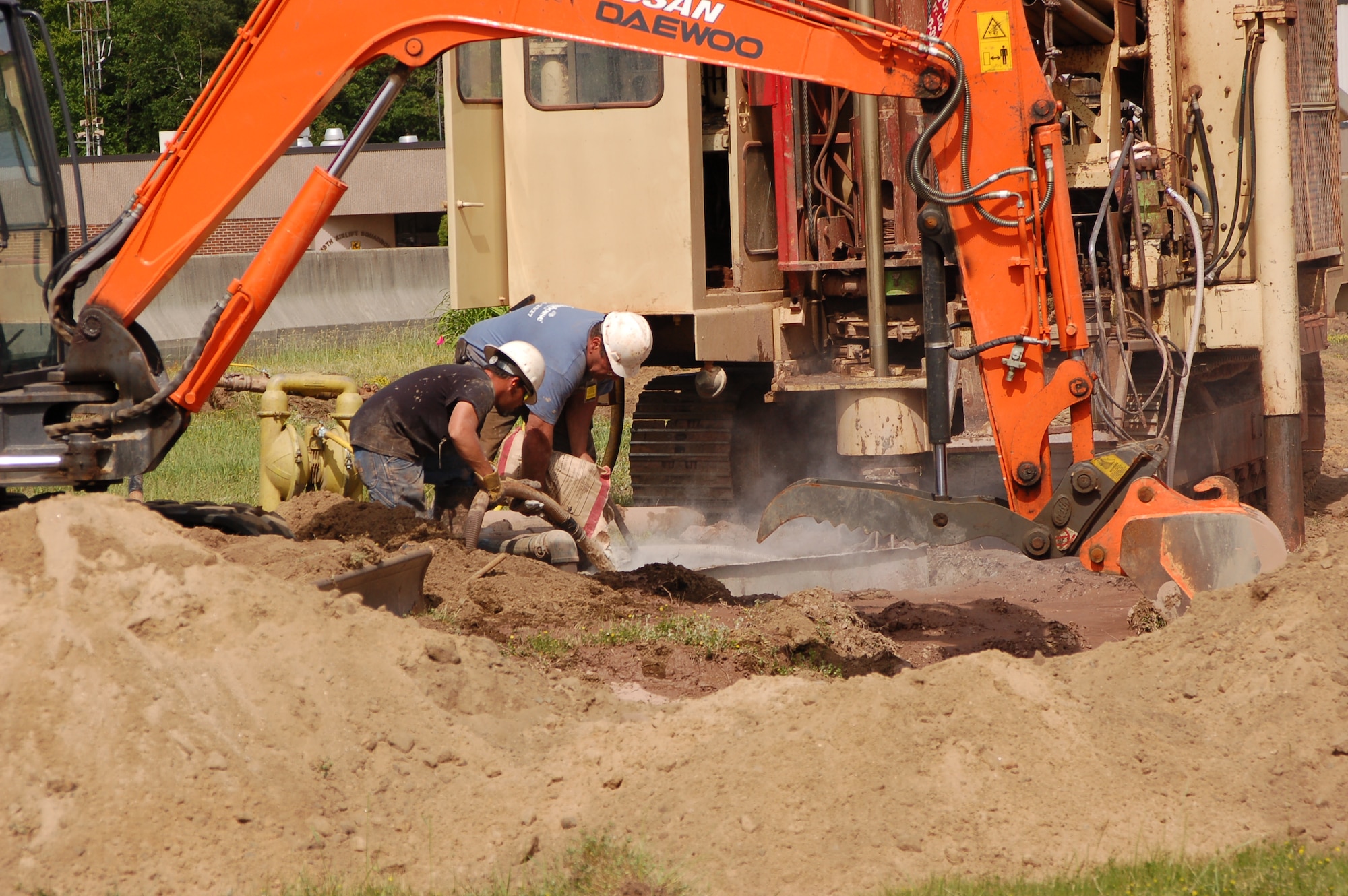 Contractors from LaFramboise Well Drilling, Inc. work at drilling the initial holes of a geo-thermal unit for building 22 at Bradley ANG Base, East Granby, Conn. June 2, 2009. This geo-thermal unit is one of 11 being installed under the Department of Energy’s energy and improvement program.  The Conn. Air National Guard is just the third base within the Guard to adopt geo-thermal technology.  (U.S. Air Force photo by Tech. Sgt. Joshua A. Mead)
