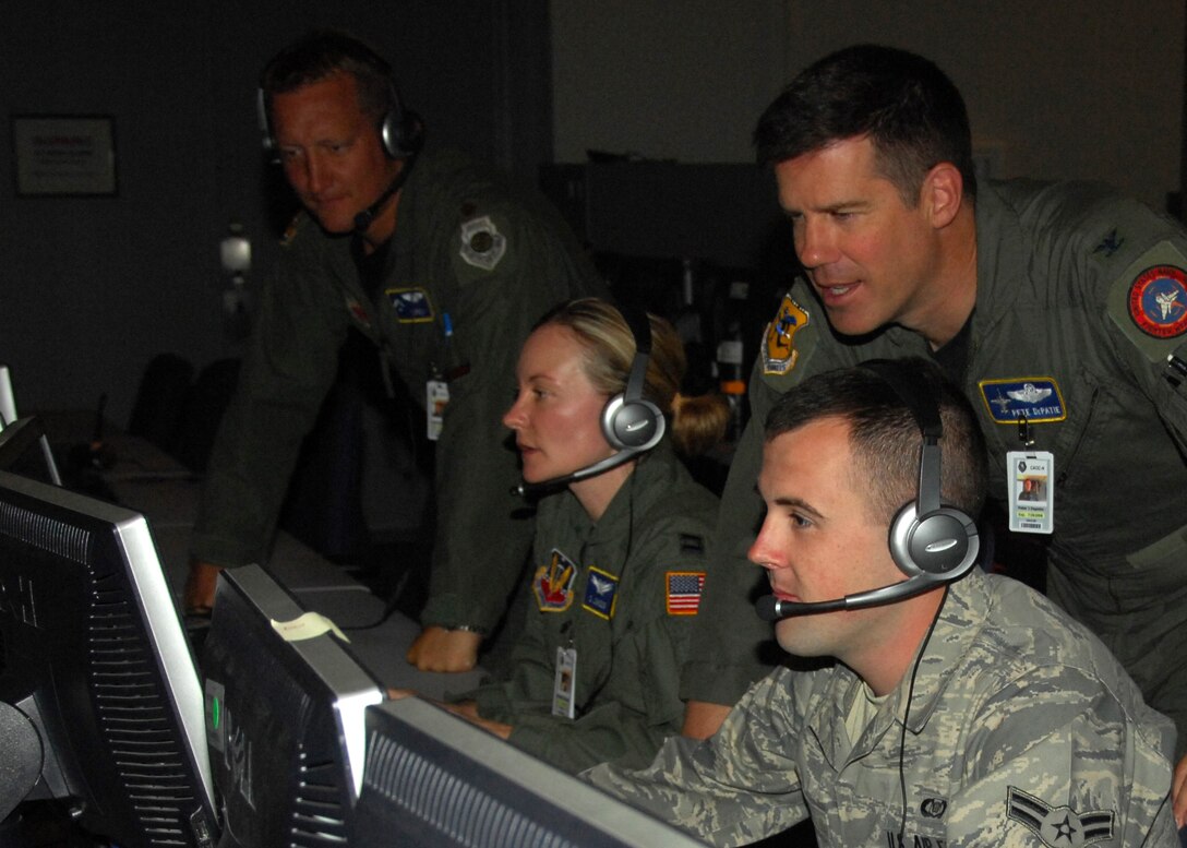 From left to right, Maj. John E. Saunders,  Capt. Dennell K. Johnson,  Airman 1st Class Mitchell D. Smith and Col. Peter J. Depatie, all members of the 103rd Air and Space Operations Group, train in the Combined Air and Operations Center at Nellis Air Force Base, Nev. during Red Flag 09-4 held July 13-24, 2009.  (U.S. Air Force photo by 2nd Lt. Emily Chilson)