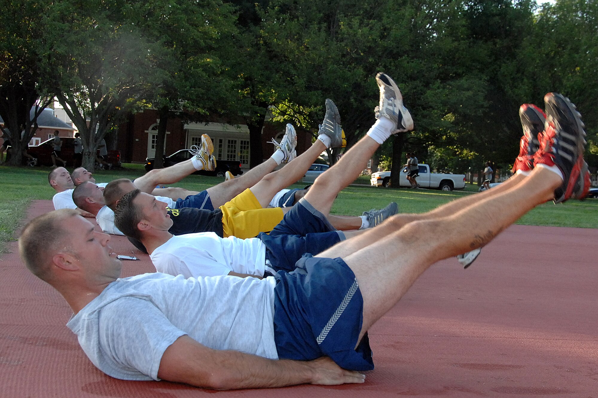 OFFUTT AIR FORCE BASE, Neb.--Tech. Sgt. DuWayne Melton, mechanic with the 55th Maintenance Squadron, Aircraft Ground Equipment Flight, does flutter kicks along with other members of the AGE Flight during Friday morning physical training on July 31 at the Offutt parade grounds.