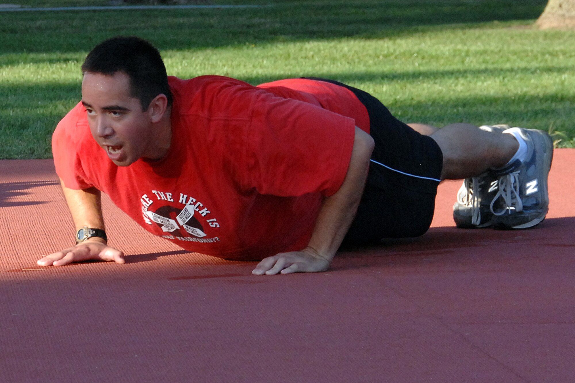 OFFUTT AIR FORCE BASE, Neb. - Staff Sgt. Adam Lee, a mechanic with 55th Maintenance Squadron, Aircraft Ground Equipment Flight, leads the flight in push-ups during a calisthenics session at the Offutt parade grounds.