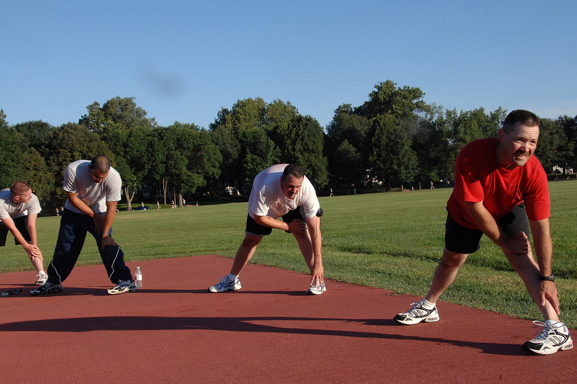 OFFUTT AIR FORCE BASE, Neb. - Master Sgt. Patrick Wolfe, first sergeant for the 55th Maintenance Squadron, Aircraft Ground Equipment Flight, joins the AGE mechanics for the flight's morning physical training July 31. The group did calisthenics and cooled down with some stretching.