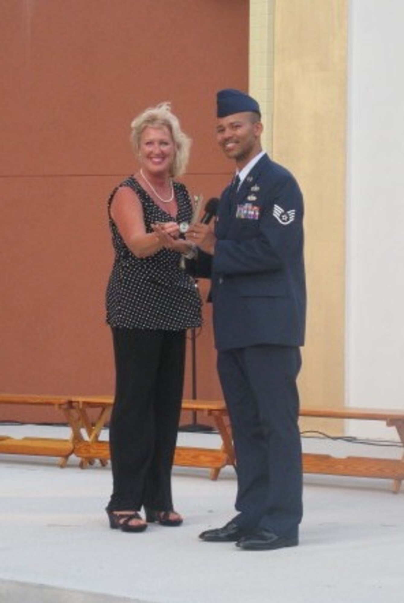 Staff Sgt. Elvan Rowe, III, 53rd Computer Systems Squadron system support adminstrator, receives the key to Destin from Sam Seevers, city councilwoman and mayor pro-tem, during the Red, White and Blue Celebration July 30.