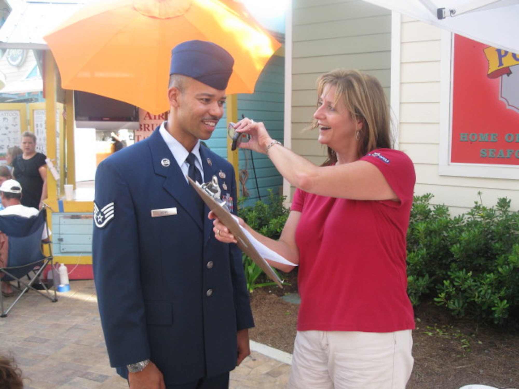 Staff Sgt. Elvan Rowe, III, 53rd Computer Systems Squadron system support adminstrator, gets interviewed by Lisa Captain, a DJ with 105.5 The Wolf radio, during the Red, White and Blue celebration in Destin, Fla., July 30.  