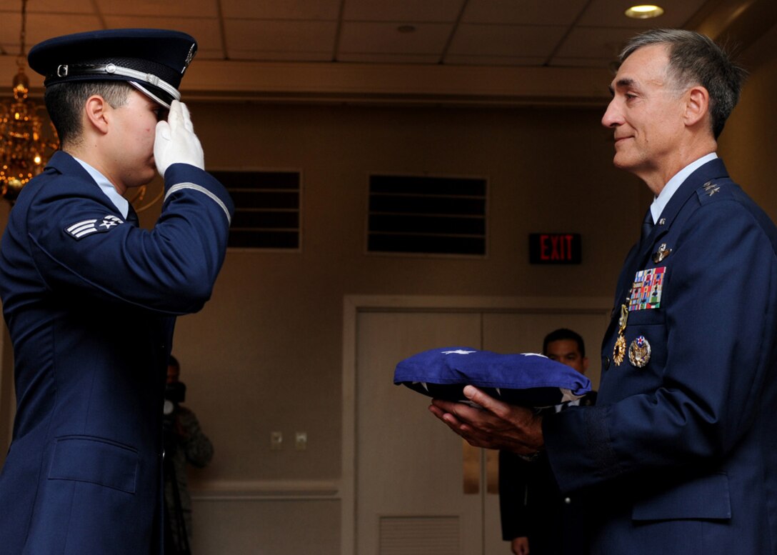 LANGLEY AIR FORCE BASE, Va. -- Maj. Gen. R. Mike Worden, Vice Commander, Air Combat Command, is presented with the U.S. flag by a member of the Langley Honor Guard during his retirement ceremony July 31. General Worden retired after 33 years of dedicated service. (U.S. Air Force photo/Amn Rebecca Montez)