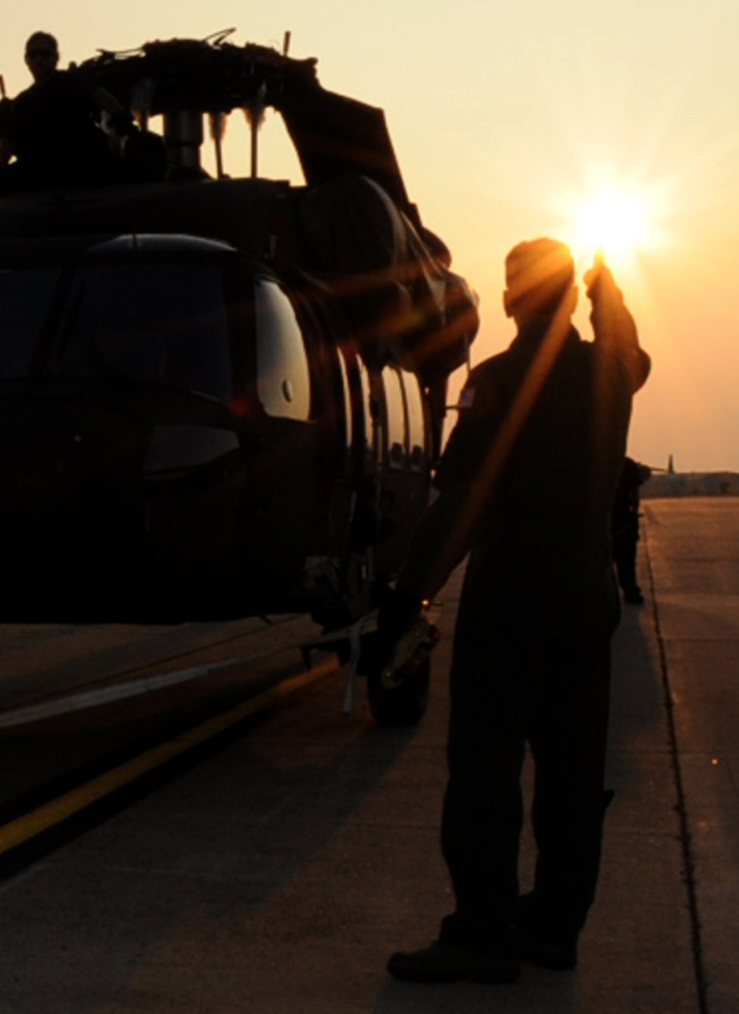 Master Sgt. Craig Essert, a loadmaster examiner with the 89th Airlift Squadron at Wright-Patterson Air Force Base, Ohio, gives a ready signal to a team of Airmen and contractors from Joint Base McGuire-Dix-Lakehurst as they prepare to load a new M-Model UH-60 Blackhawk onto to a C-5 on the Joint Base MDL airfield Thursday. The helicopter, along with three others, was flown out to Hawaii to replace aging Blackhawks utilized by the Army in the Pacific. (U.S. Air Force photo/Staff Sgt. Danielle Johnson)