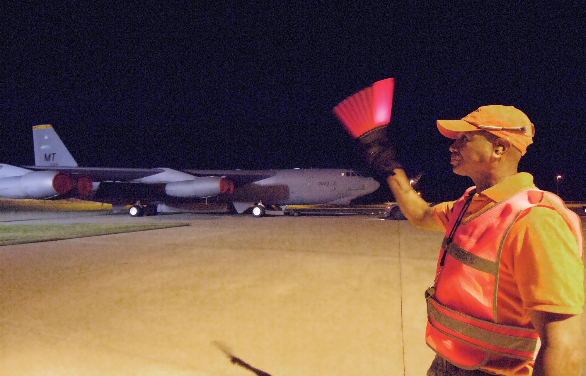 Illuminated only by hangar lights at Tinker and the Boeing-operated Maintenance, Repair and Overhaul Technology Center across Douglas Boulevard, a B-52 is moved in pre-dawn hours to the MROTC for further maintenance. Walking wing tip with the aircraft to ensure a safe transition is Antonio Stevenson, a member of Tinker’s 566th Aircraft Maintenance Squadron. (Air Force photo by Margo Wright)