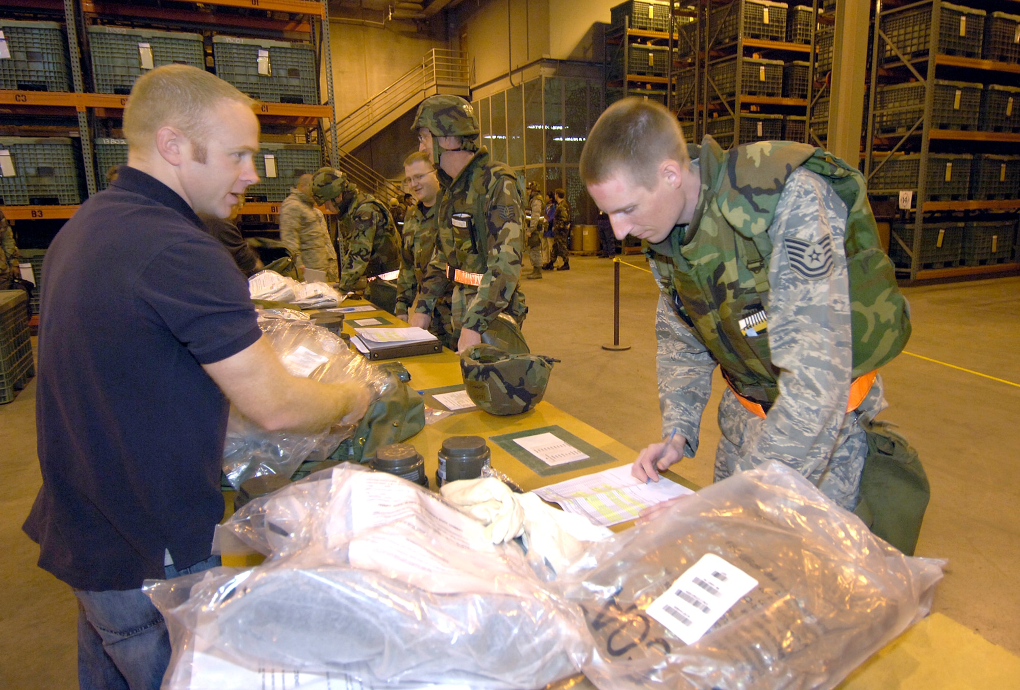 During a recent deployment exercise, Tech. Sgt. Stephen Getten, 76th Aircraft Maintenance Group, checks his mobility bag gear with help from Troy Dooley, 72nd Logistics Readiness Squadron.  (Air Force photo by Margo Wright)