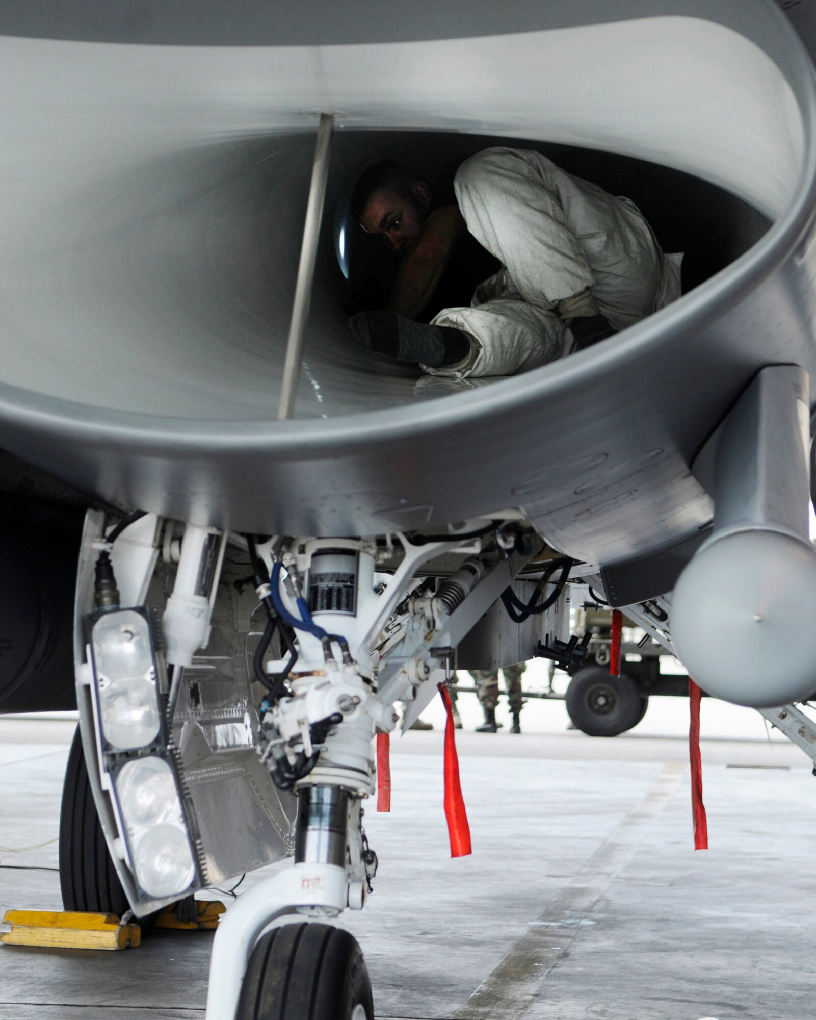 Staff Sgt. Chad Marks performs a post-flight inspection inside an F-16 Fighting Falcon after the aircraft was flown in a Red Flag 09-3 exercise July 28, 2009, Eielson Air Force Base, Alaska. RF-A is a Pacific Air Forces-directed field training exercise for U.S. and coalition forces under simulated air-combat conditions. Sergeant Marks is assigned to the 169th Aircraft Maintenance Squadron, McEntire Joint National Guard Base, South Carolina. (U.S. Air Force photo/Airman 1st Class Laura Goodgame)