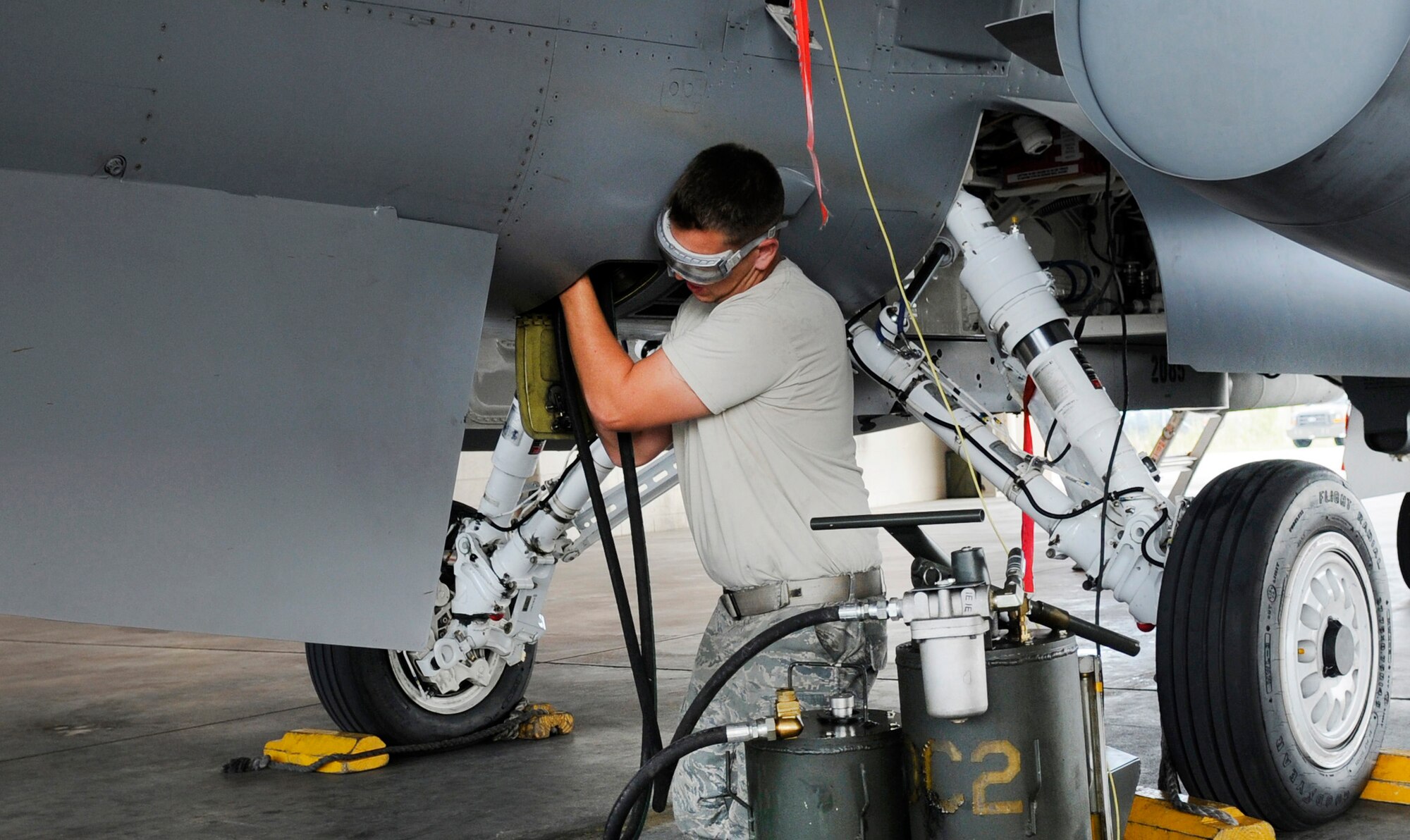Senior Airman Chris Mitchell performs an oil service on an F-16 Fighting Falcon between flights during Red Flag Alaska 09-3 exercises July 28, 2009, Eielson Air Force Base, Alaska. RF-A is a Pacific Air Forces-directed field training exercise for U.S. and coalition forces flown under simulated air-combat conditions. Airman Mitchell is a crew chief assigned to the 169th Aircraft Maintenance Squadron, McEntire Joint National Guard Base, South Carolina. (U.S. Air Force photo/Airman 1st Class Laura Goodgame)