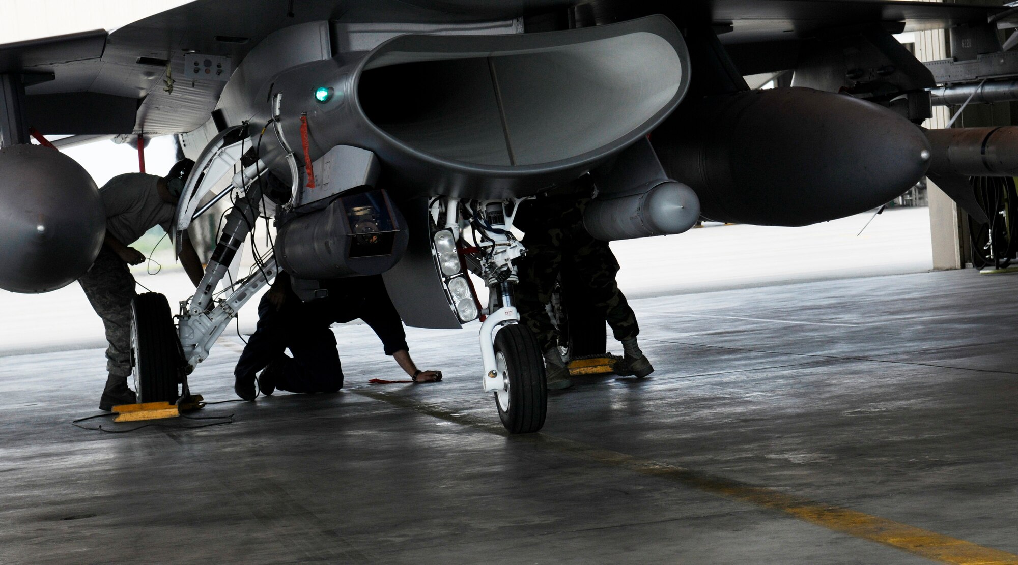 Swamp Fox Crew Chiefs perform post flight inspections on an F-16 Fighting Falcon during RED FLAG-Alaska 09-3 July 28, 2009, Eielson Air Force Base. RF-A is a Pacific Air Forces-directed field training exercise for U.S. and coalition forces flown under simulated air-combat conditions. The Swamp Fox's are assigned to the 169th Aircraft Maintenance Squadron, McEntire Joint National Guard Base, South Carolina. (U.S. Air Force photo/Airman 1st Class Laura Goodgame)
