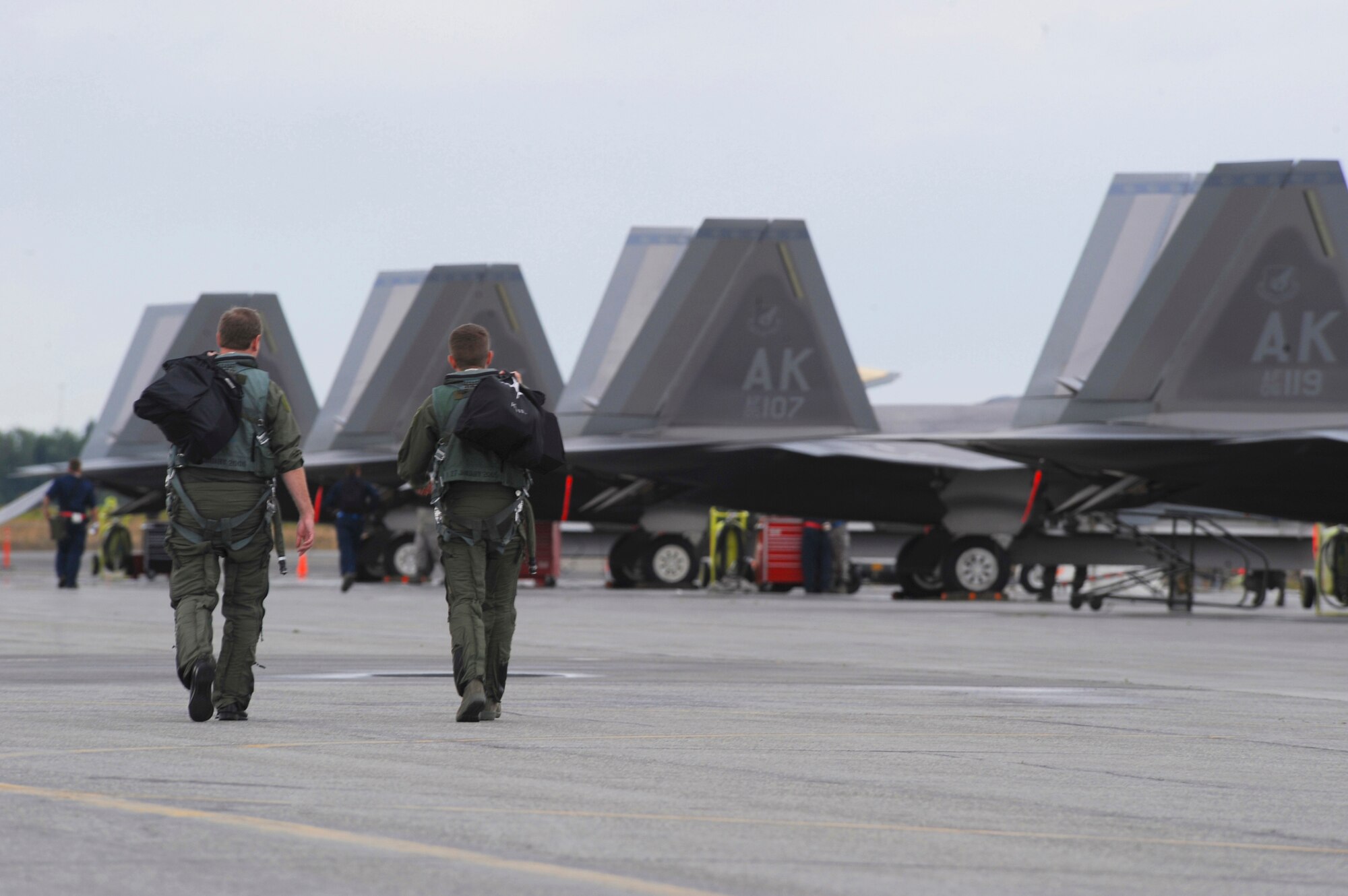 ELMENDORF AIR FORCE BASE, Alaska -- Maj. Kevin Sutterfield (left) and Capt. Adam Keith step to their F-22 Raptors during Red Flag-Alaska 09-3 July 29. Red Flag-Alaska is a Pacific Air Forces commander-based field training exercise for U.S. coalition forces flown under simulated air combat conditions. It provides joint offensive counter-air, interdiction close air support, and large force employment training in a simulated combat environment. Sutterfield is a member of the 302nd Fighter Squadron and Keith is a member of the 90th Fighter Squadron. (U.S. Air Force photo/Senior Airman Matthew Owens)