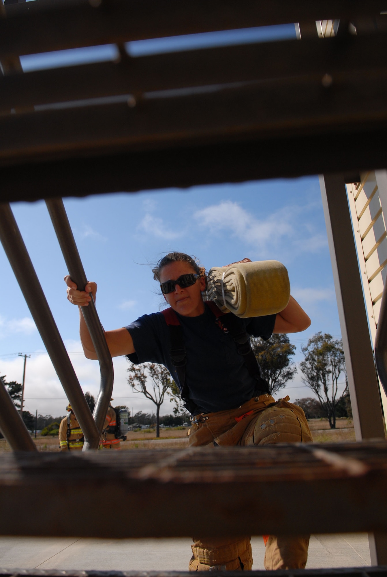 VANDENBERG AIR FORCE BASE, Calif. -- Fighting against the stairs, Marissa Halbeisen, a 30th Civil Engineer Squadron firefighter, rushes up a four-story flight of stairs during training July 29 here in preparation for the Firefighter Combat Challenge in October. This is the team’s first time competing in the championship competition. The challenge seeks to encourage firefighter fitness and demonstrate the profession's rigors to public. The competitors race head-to-head as they simulate the physical demands of real-life fire fighting by performing a linked series of five tasks, including climbing the five-story tower, hoisting, chopping, dragging hoses and rescuing a life-size, 175-pound "victim" as they race against their opponents and the clock.  (U.S. Air Force photo/Senior Airman Bryan Boyette)
