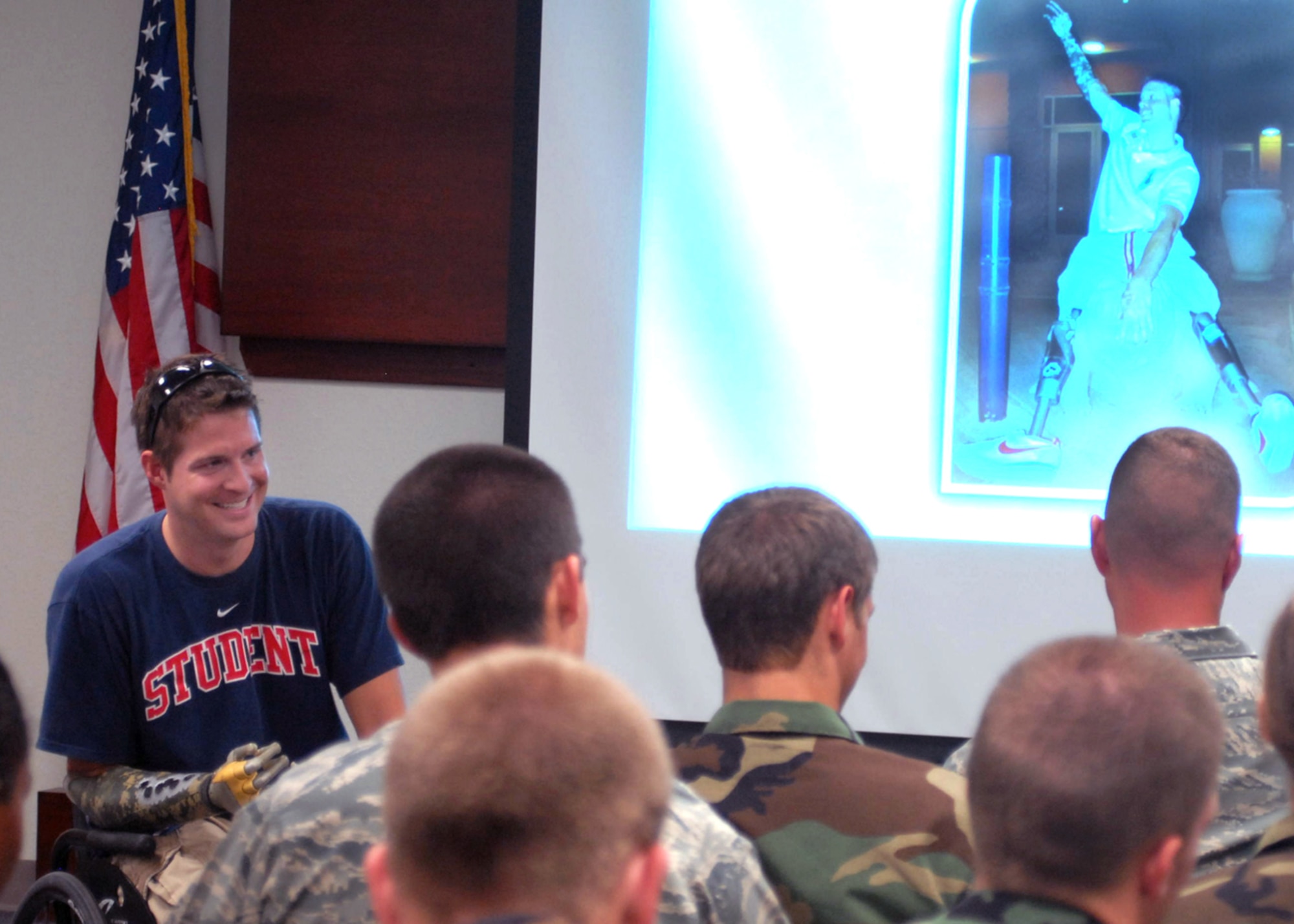 Brian Kolfage Jr. speaks to an audience that included 17th Security Forces Squadron defenders and ROTC cadets July 2 at Goofellow Air Force Base, Texas. He spoke about a rocket attack in Iraq on Sept. 11, 2004, which left him without legs and a right arm. Mr. Kolfage is a former 17th Security Forces Squadron defender and now a retired senior airman. (U.S. Air Force photo/Robert D. Martinez)