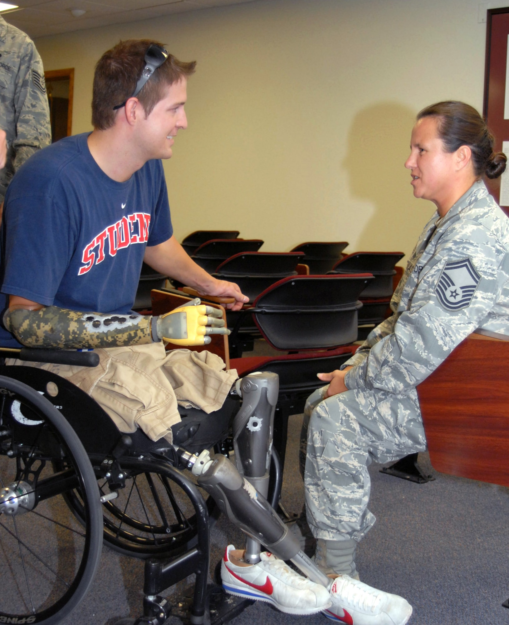 Brian Kolfage Jr. speaks to Senior Master Sgt. Annette Whitenack July 2 at Goodfellow Air Force Base, Texas. Mr. Kolfage spoke about his experience on Sept. 11, 2004, when a rocket attack left him without legs and a right arm. Sergeant Whitenack was one of the first medical responders on scene after he was injured. Mr. Kolfage is a former 17th Security Forces Squadron defender and now a retired senior airman. (U.S. Air Force photo/Robert D. Martinez)