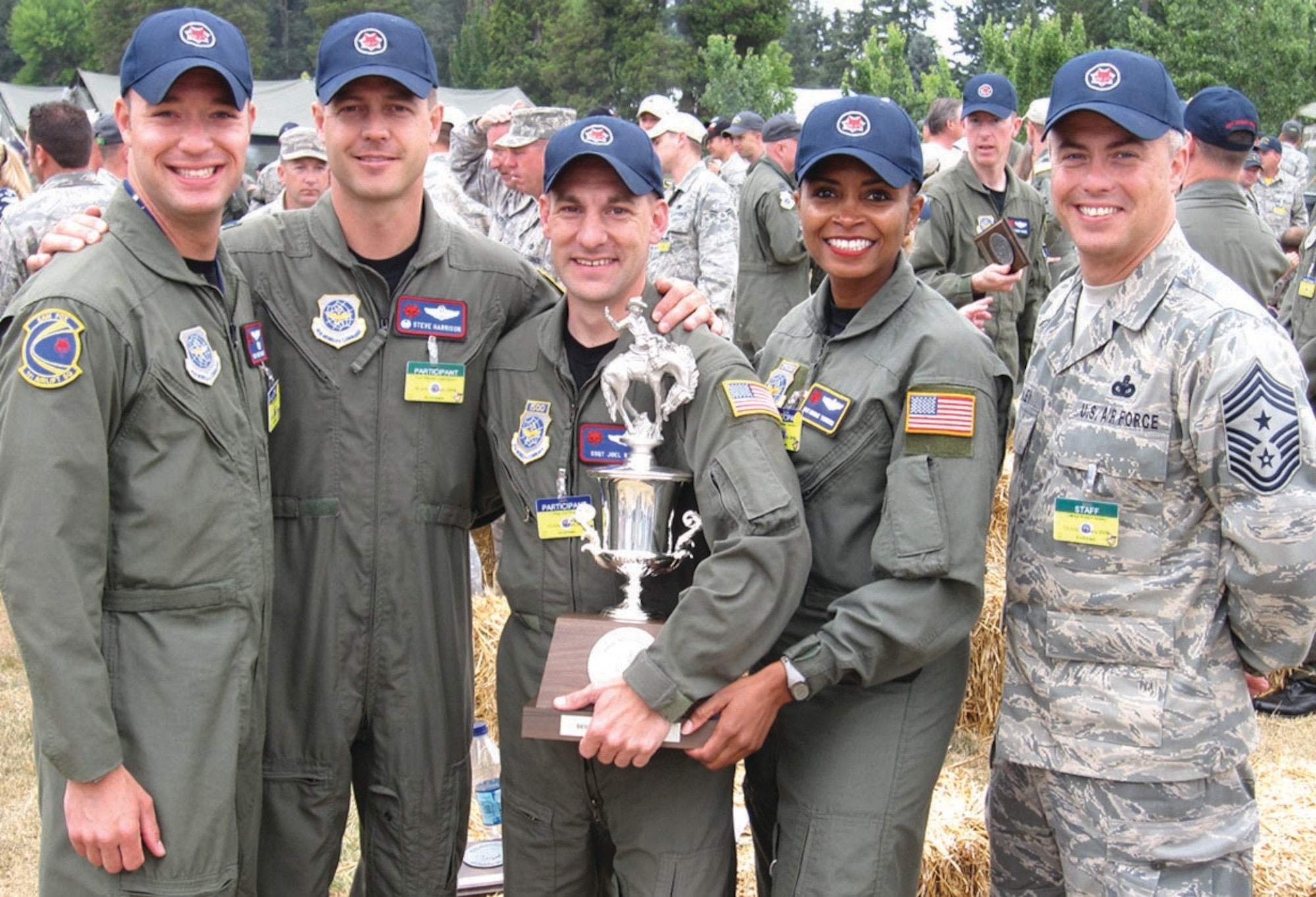From left to right: Tech. Sgt. Bret Baker, 1st Airlift Squadron special air missions flight attendant, Col. Steve Harrison, 89th Airlift Wing commander, Staff Sgt. Joel Rose, 1st Airlift Squadron special air missions flight attendant, Master Sgt. Monique "Mo" Townsend, 89th Operations Group special air missions flight attendant, and Chief Master Sgt. Robert Sealey, 89 AW command chief master sergeant, pose with the 1st place trophy for the Flight Attendant Egress Competition at the 2009 Air Mobility Command Rodeo at McCord AFB, Wash., July 24. Four teams competed in the competition which consisted of an aircraft evacuation following a simulated 'planned emergency landing.' They were scored based on preflight of emergency equipment, giving appropriate briefings and following aircraft procedures. (U.S. Air Force photo/ Airman 1st Class Patrick McKenna)
