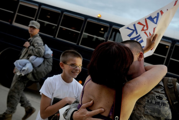 MOODY AIR FORCE BASE, Ga. -- Tech. Sgt. Mark Carlson, a member of the 23rd Equipment Maintenance Squadron member from St. Marys, Ga., hugs his wife here July 30, after returning from a deployment to Bagram Air Field, Afghanistan. (U.S. Air Force photo by Senior Airman Gina Chiaverotti-Paige)