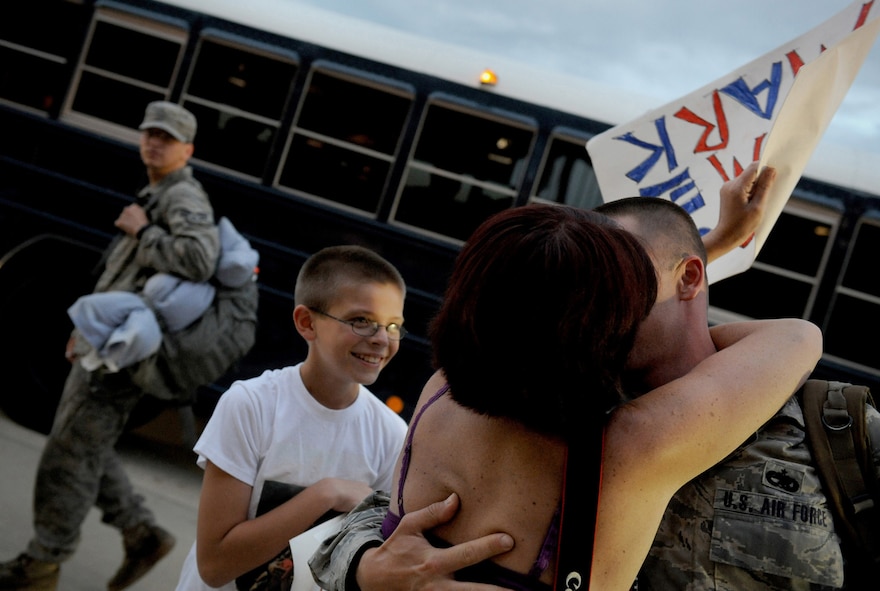MOODY AIR FORCE BASE, Ga. -- Tech. Sgt. Mark Carlson, a member of the 23rd Equipment Maintenance Squadron member from St. Marys, Ga., hugs his wife here July 30, after returning from a deployment to Bagram Air Field, Afghanistan. (U.S. Air Force photo by Senior Airman Gina Chiaverotti-Paige)