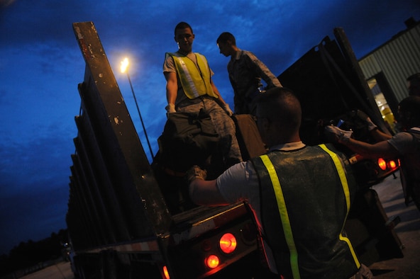 MOODY AIR FORCE BASE, Ga. -- Members of the 23rd Logistics Readiness Squadron and augmentees help off load baggage from a truck during a homecoming here July 30. The 74th Fighter Squadron and 74th Aircraft Maintenance Unit returned from a deployment to Afghanistan. (U.S. Air Force photo by Senior Airman Gina Chiaverotti-Paige)