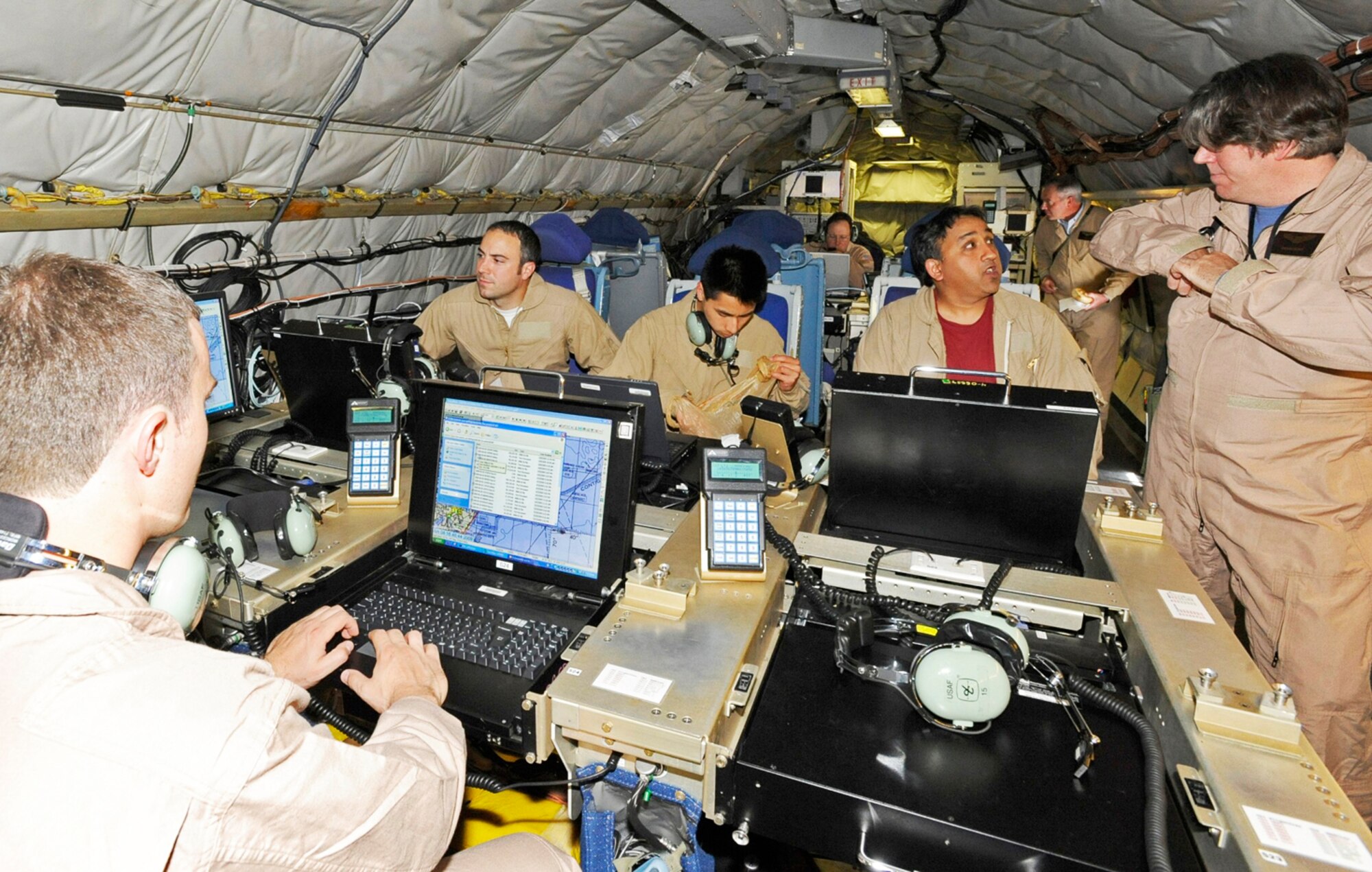 Advanced Multiband Communications Antenna System program team members pass data and monitor location and flight conditions after successfully connecting to the MILSTAR satellite during a June test flight at Hanscom Air Force Base, Mass. The test flight confirmed the utility of a small but powerful antenna that will enable aircrews to receive extremely high frequency satellite communications. (Courtesy photo) 