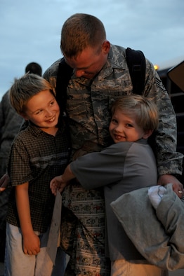MOODY AIR FORCE BASE, Ga. -- Staff Sgt. Jason White, 74th Fighter Squadron medical technician from Melbourne, Fla., hugs his children during a homecoming here July 30. Sergeant White was deployed for five months to Afghanistan. (U.S. Air Force photo by Senior Airman Gina Chiaverotti-Paige)